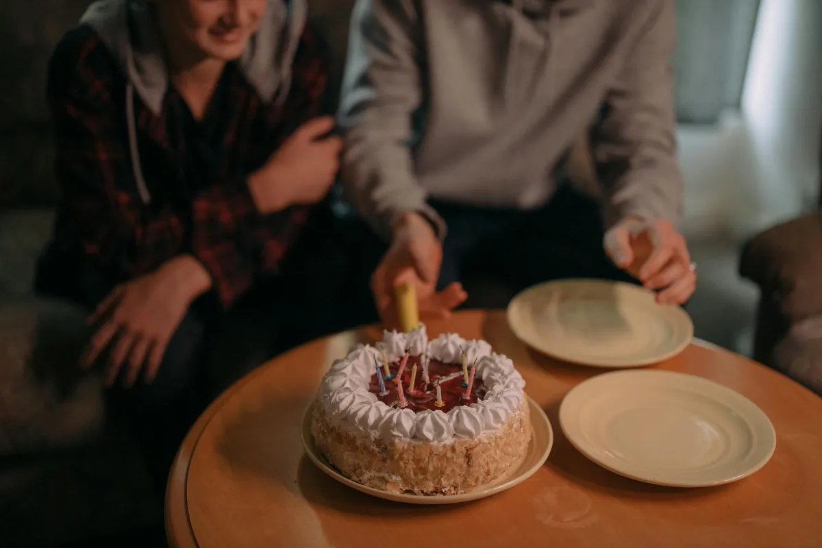 Birthday candles being lit on a cake
